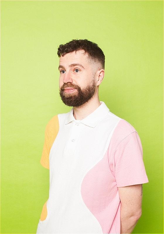 Danny staring off-camera against a pale yellow background
