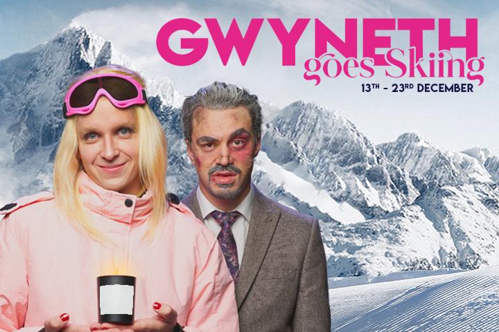 A smiling Linus as Gwyneth Paltrow wearing a pink ski suit and pink skiing googles and a bruised Joseph as Terry Sanderson stand against a snowy mountain background. In pink font, Gwyneth Goes Skiing and the performance dates between 13th - 23rd December stand out on the right hand side.