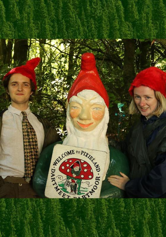 Ada and Bron stand either side of a large garden gnome wearing matching hats