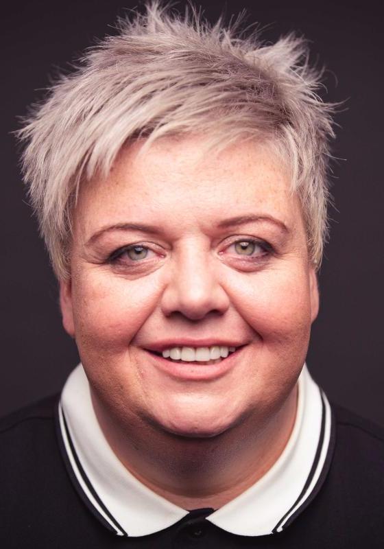 Colour headshot of Susie McCabe who wears a black polo shirt with a white collar.