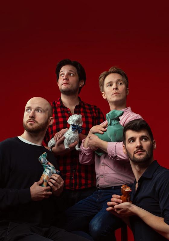 Shoot from the Hip troupe stand in a staged photograph set-up, each holding a porcelain dog.
