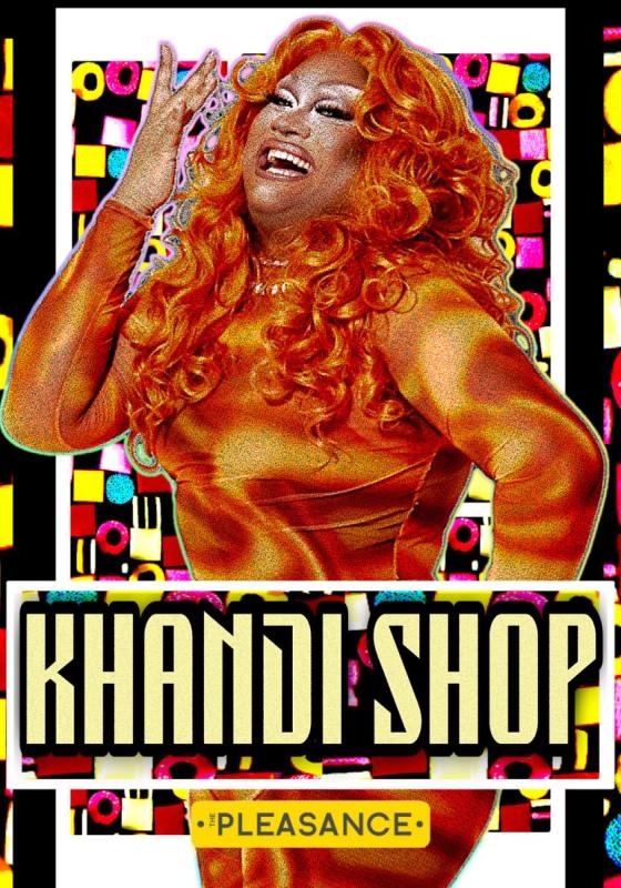 Mahatma stands all in an orange wig and orange outfit smiling delightfully at the camera in front of an edited, liquorice-inspired backdrop.