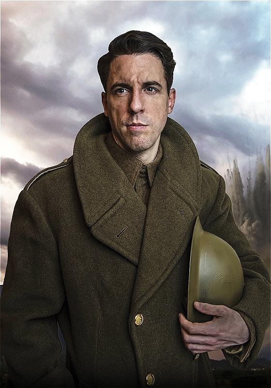 David dressed as a WW2 soldier holding his helmet under his arm.