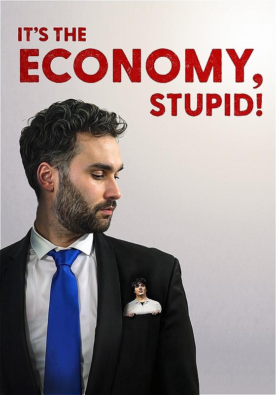 A performer wears a black suit and blue tie. A picture of a person is coming out their front pocket. The show title is in red - 'It's the Economy, Stupid!'