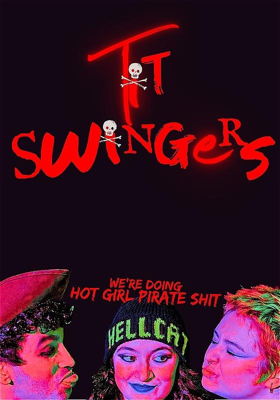 A performer wears a beanie that says 'Hellcats'. There is a person either side of them, each pulling faces. 