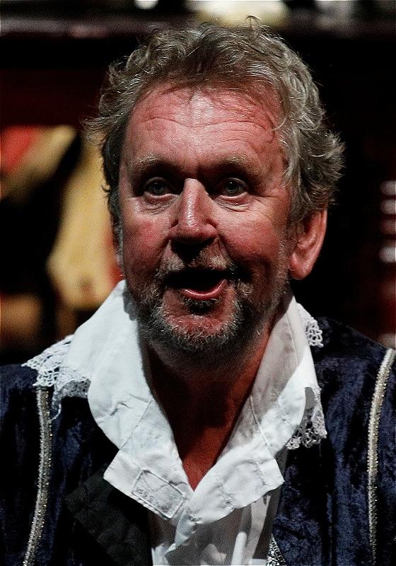 Close-up of the performers face with his mouth slightly ajar.