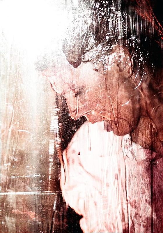 Abstract artistic image of a person's profile with distorted visual effects that mimic wet glass or running paint, creating a blurred and textured appearance. The predominant colors are shades of pink and white, imparting a dreamy, ephemeral quality to the image.