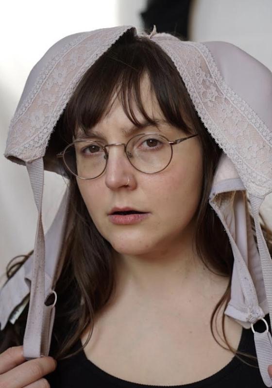 Image of Jessica Aszkenasy, performer, wearing a bra on their head