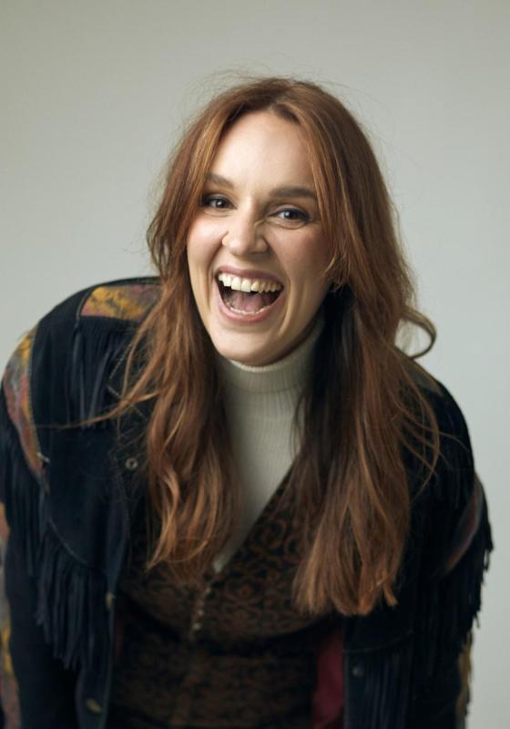 A person laughing with her mouth open
