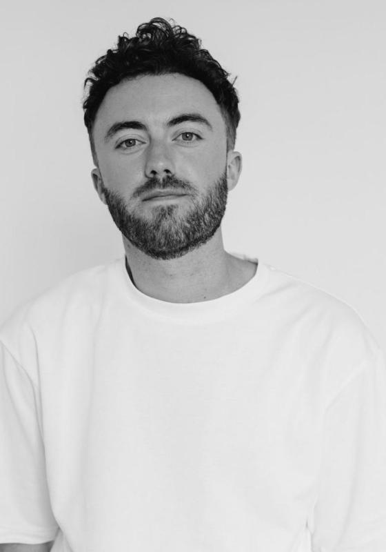Black and white headshot of the performer