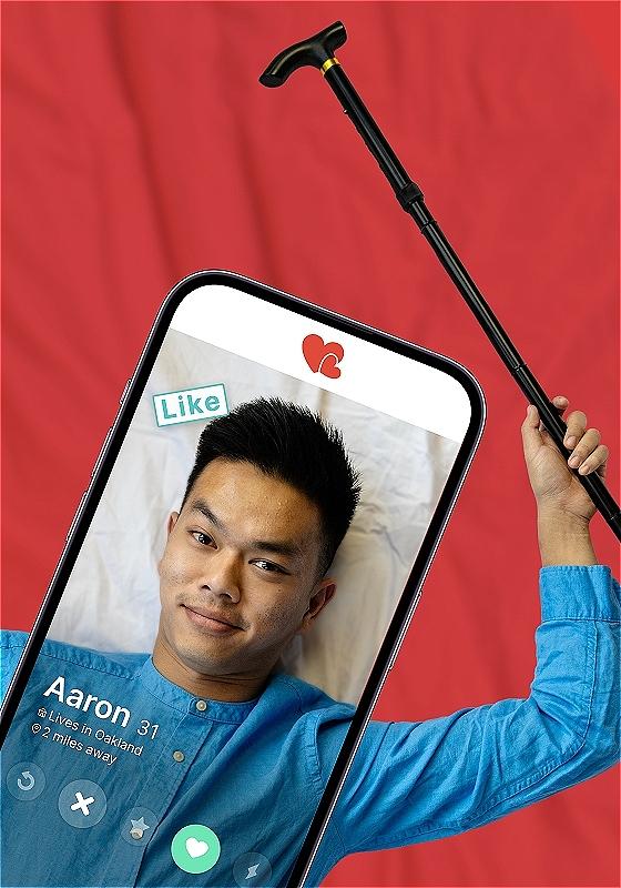 Aaron is on a dating app, the profile reads Aaron, 31 with a like message on it. holding a cane in their right hand. 