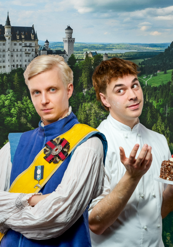 The prince looking into the camera whilst the baker looks bewildered holding a black forest gateau