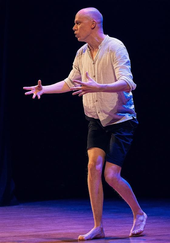 Jordan walking on stage - the light is purple