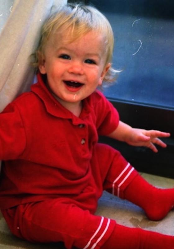 An image of a toddler Ivo smiling. 