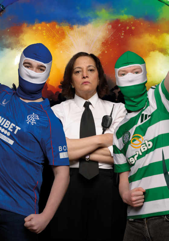 Two people wearing sports kits holding green and blue flares above their heads. 