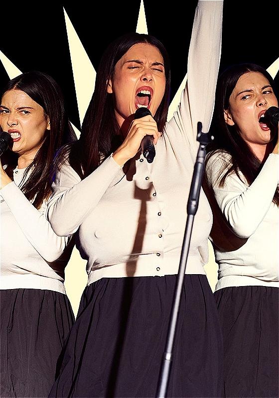 Three Patti Harrisons bellow and grimace whilst adorning large fake breasts which hang from their chests under a white cardigan