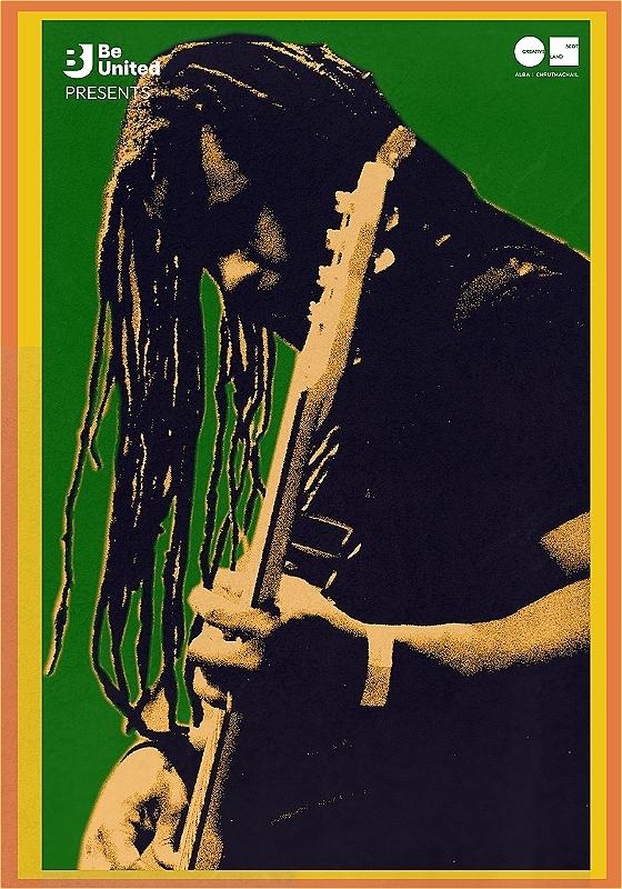 Photo of a musician playing guitar surrounded by green, yellow and orange Caribbean colours.