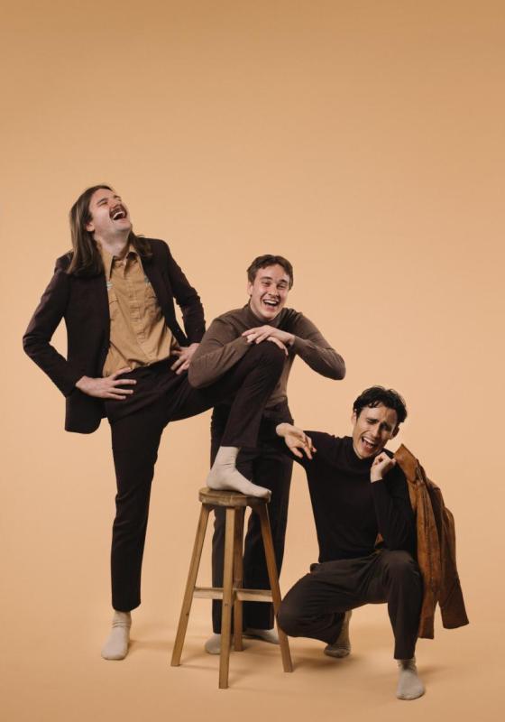 The cast of crybabies laughing intensely wearing brown and earth tones 