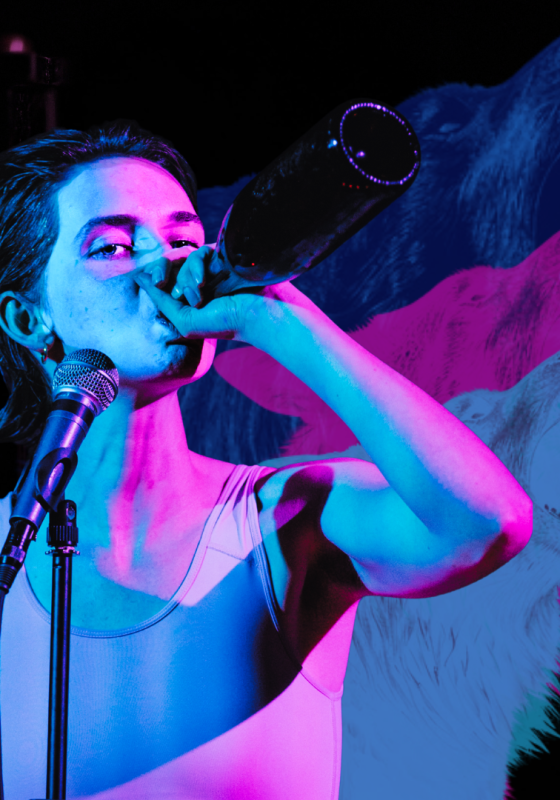 An actor takes a swig from a bottle in front of a microphone. Wolves howling in the background with blue and pink lighting.