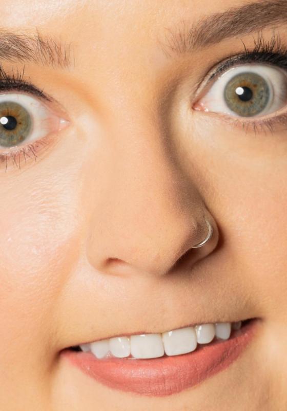 Extreme zoom in of the performer's face, showing her eyes, nose, and mouth