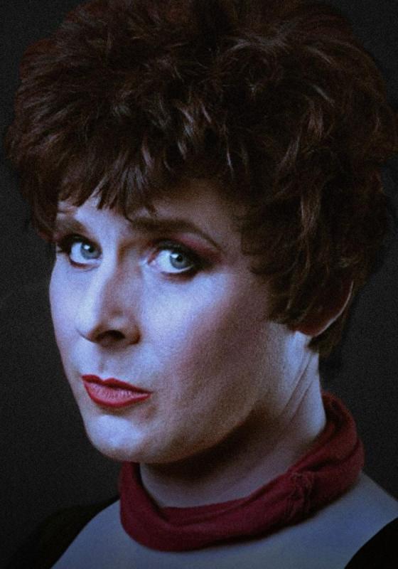 Colin Hoult as Anna Mann staring pensively at the camera with a gloomy filter