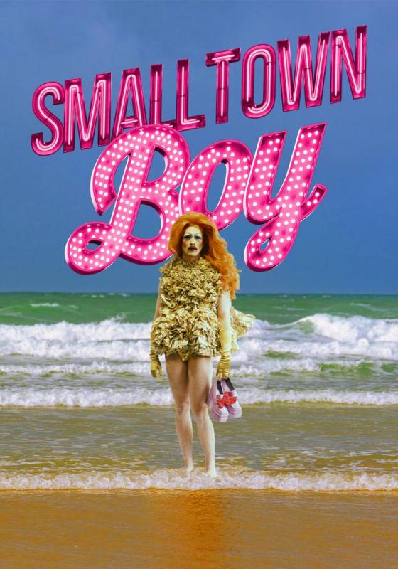 Smalltown Boy in pink lights behind someone holding shoes on a beach