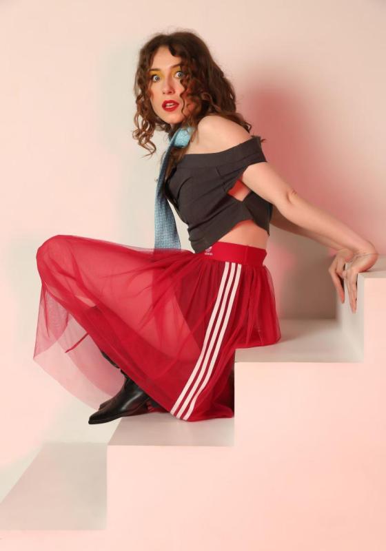 Photo of Holly climbing a white staircase and looking apprehensive.