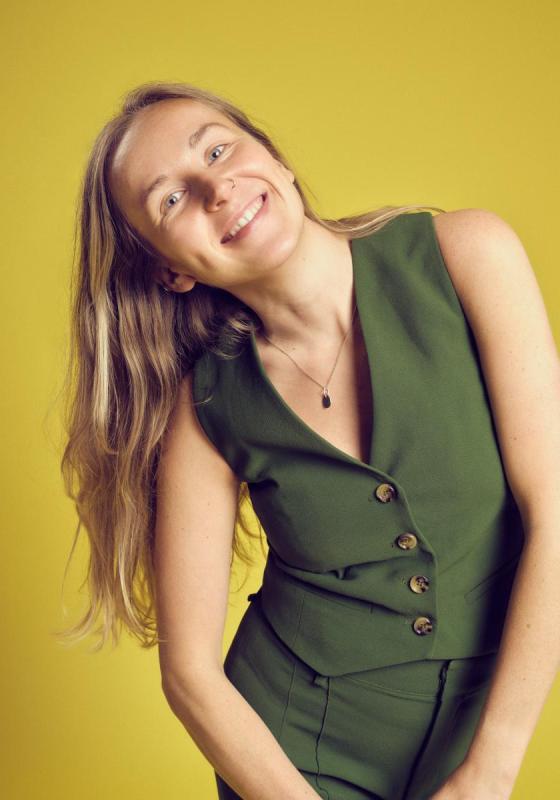 Courtney leaning and smiling at the camera