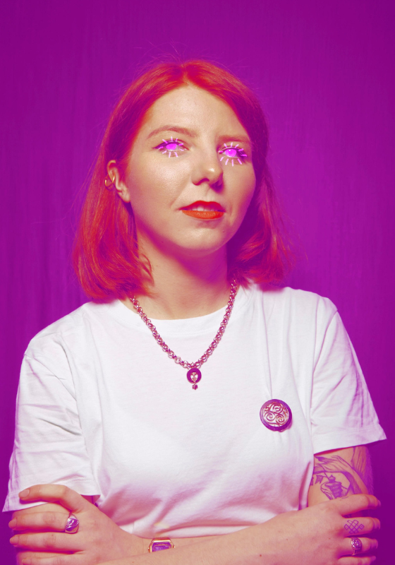 A purple toned image of Marty with their eyes glowing pink neon.