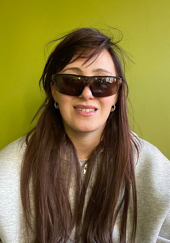 Photo of performer wearing sunglasses and a hoodie.