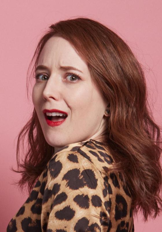 Freya looking over her shoulder in shock wearing a leopard print top.