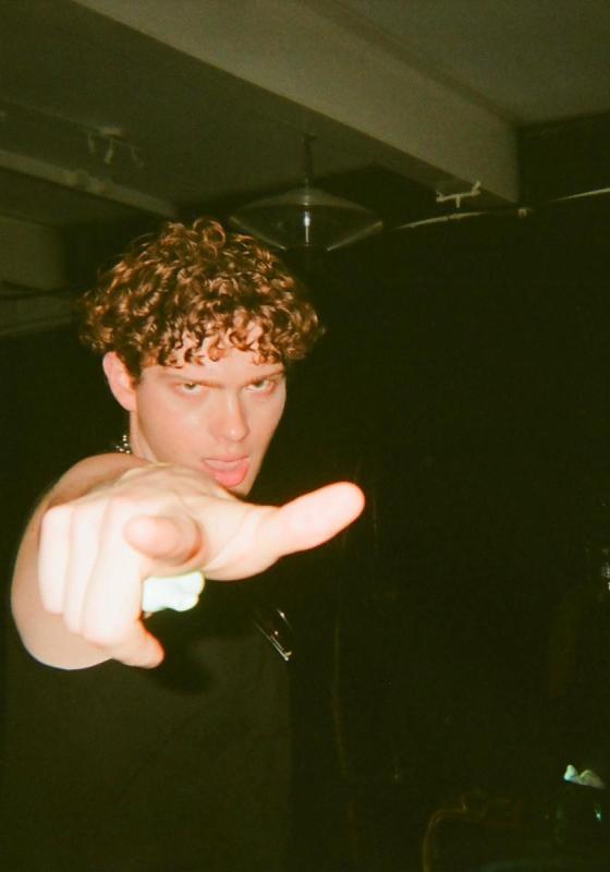 Photo of a person pointing their finger directly towards the viewer.