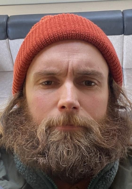 Selfie of Rob in an orange beanie.