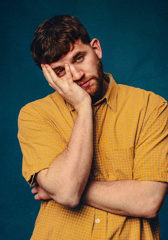 Photo of Rory with arms folded, one hand holding up his face.