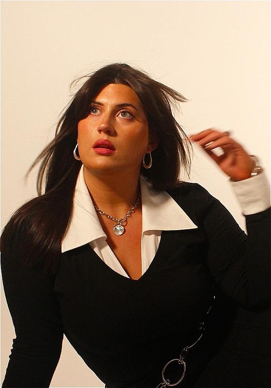 Headshot of Maia posing with windswept hair.