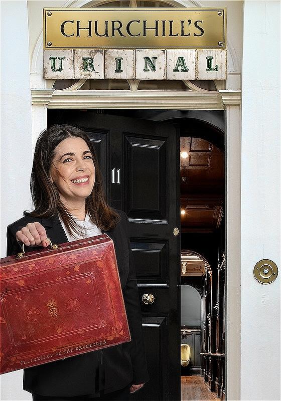 A woman wearing a black blazer holds a red suitcase in front of a black door marked 11 that is slightly ajar, leading into a dark hallway with a shining urinal at the end.