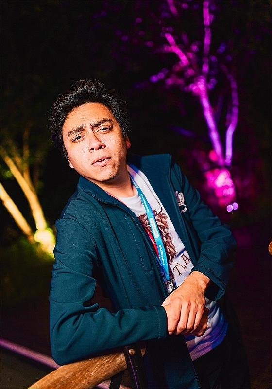 Martin looks inquisitively into the camera, leaning against a railing casually with his elbow. He's wearing a Pleasance lanyard, probably thinking we wouldn't notice one is missing.