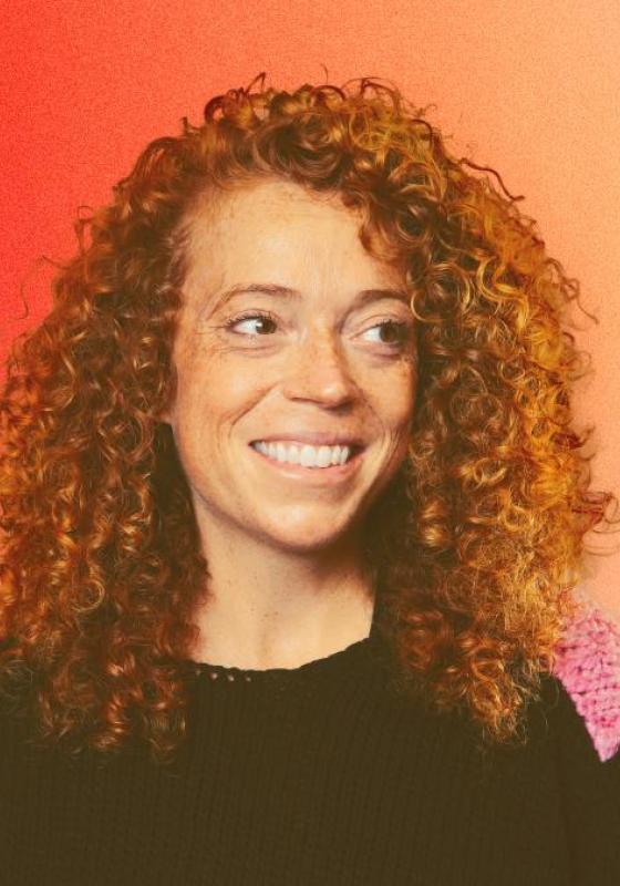 Photo of Michelle Wolf, smiling.