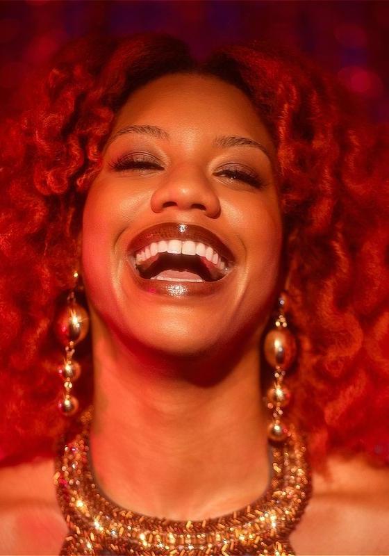 Portrait of Kemah wearing big gold jewelry while laughing