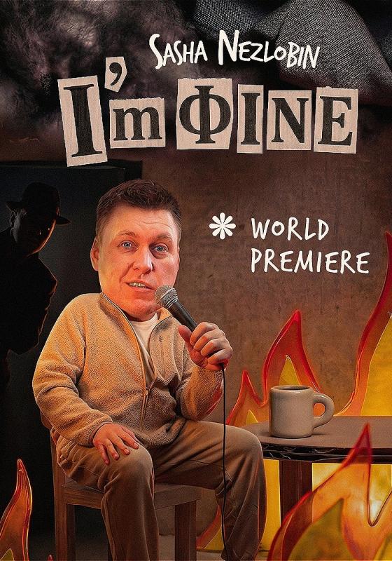 Sasha sits with a microphone at a table. The fire around them is ablaze. A doorway behind him shows a dark figure peering into the room. 