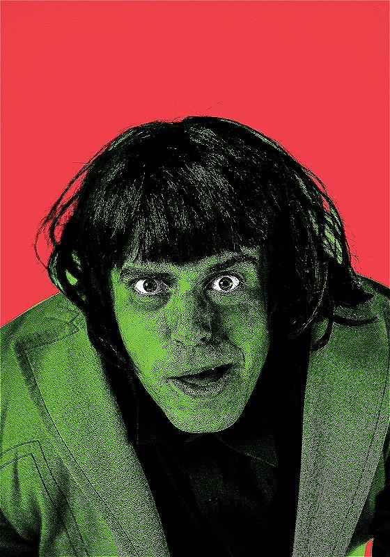 An individual with short black hair stares at the camera. Their skin and clothes are tinted green, highly contrasting with the vivid red background.
