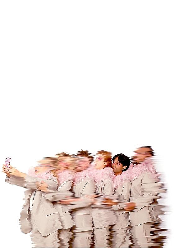 Blurry people with one in focus holding a phone