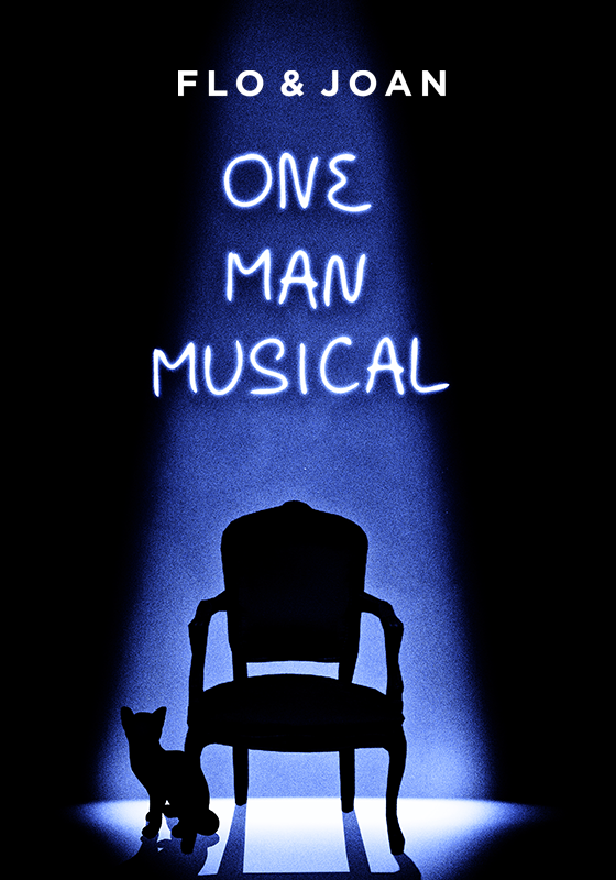 An empty chair is lit by a single spotlight. The outline of a cat can be seen at the spotlight's edge. Above the chair the show's title, One Man Musical, is written.