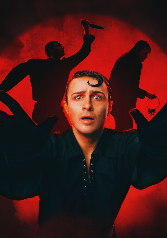 White man in black dress shirt and gloves reaches towards you with scared face and a curl in his hair. Background is a red spotlight with silhouette of two figures holding a knife and a set of keys.
