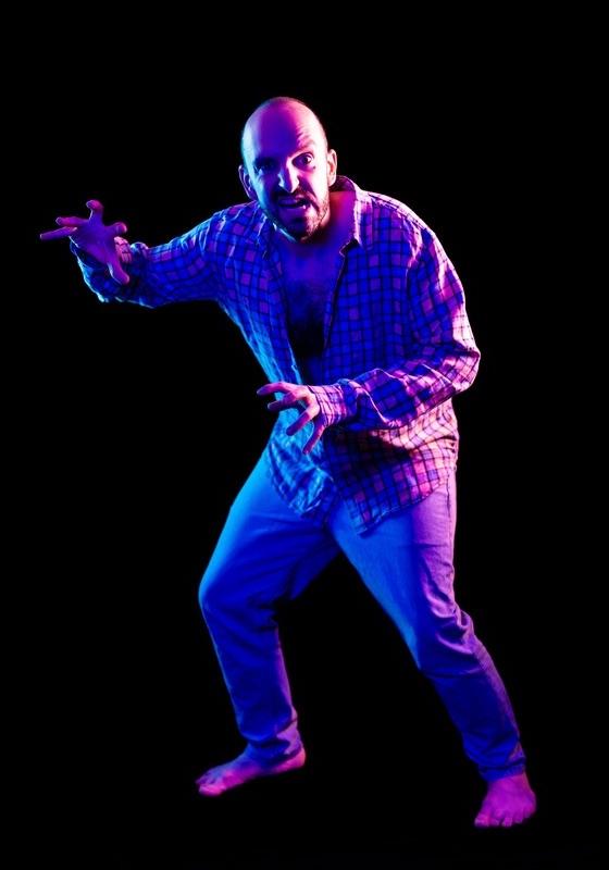 A man in a fighting stance with claw hands.