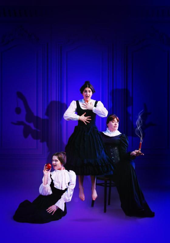 Three women in period dress: one holding an apple, one holding a lit dynamite and one levitating.