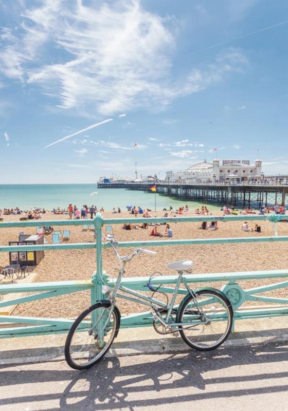 A sunny photograph of a bicycle on Brighton Beach.