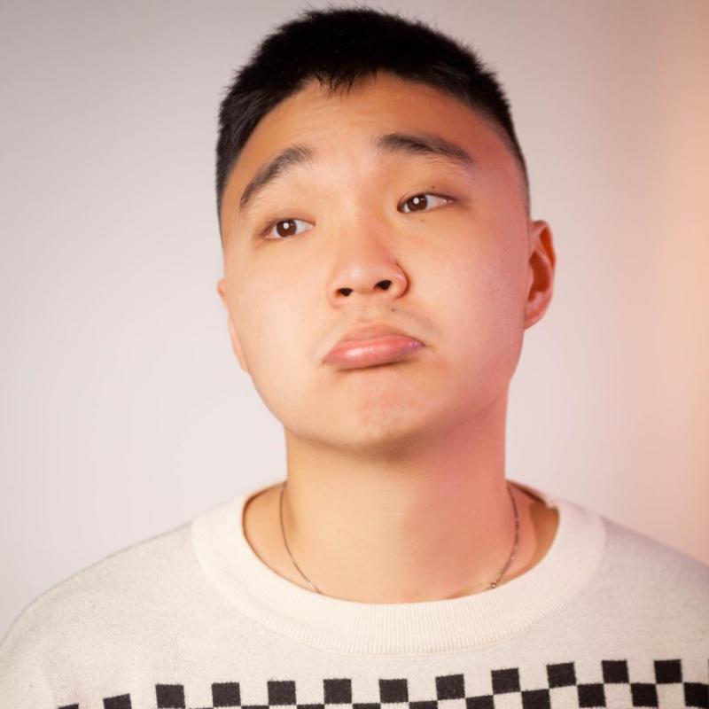 JinHao LI pouting in a white graphic top