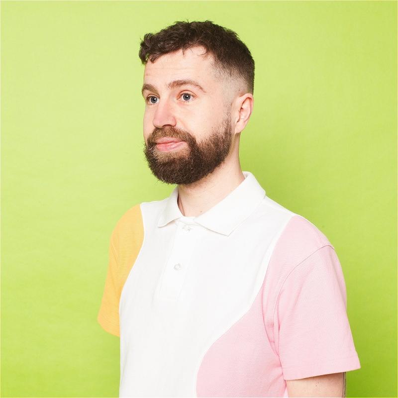Danny staring off-camera against a pale yellow background