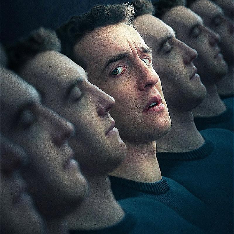 Artistic rendering of multiple identical male faces in a row with a gradual focus toward one central face looking perplexed or concerned among others in a passive state, all wearing dark sweaters against a dimly lit background.